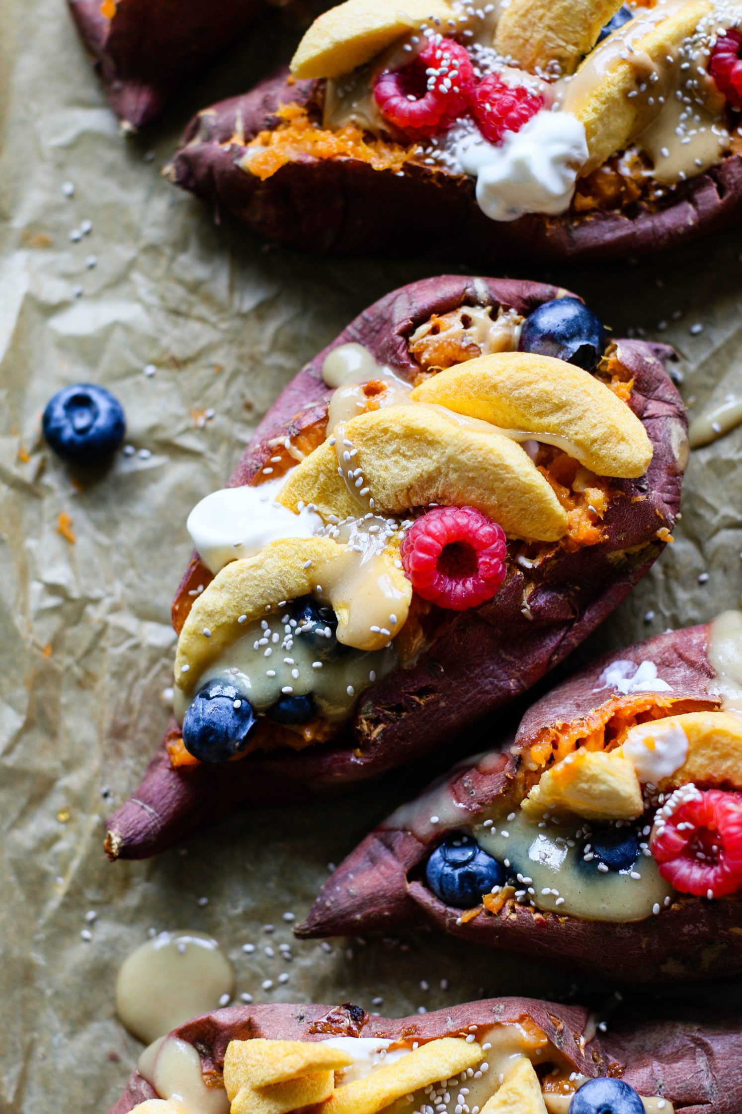 Stone Fruit Stuffed Sweet Potatoes served parchment lined baking sheet with Maple Tahini
