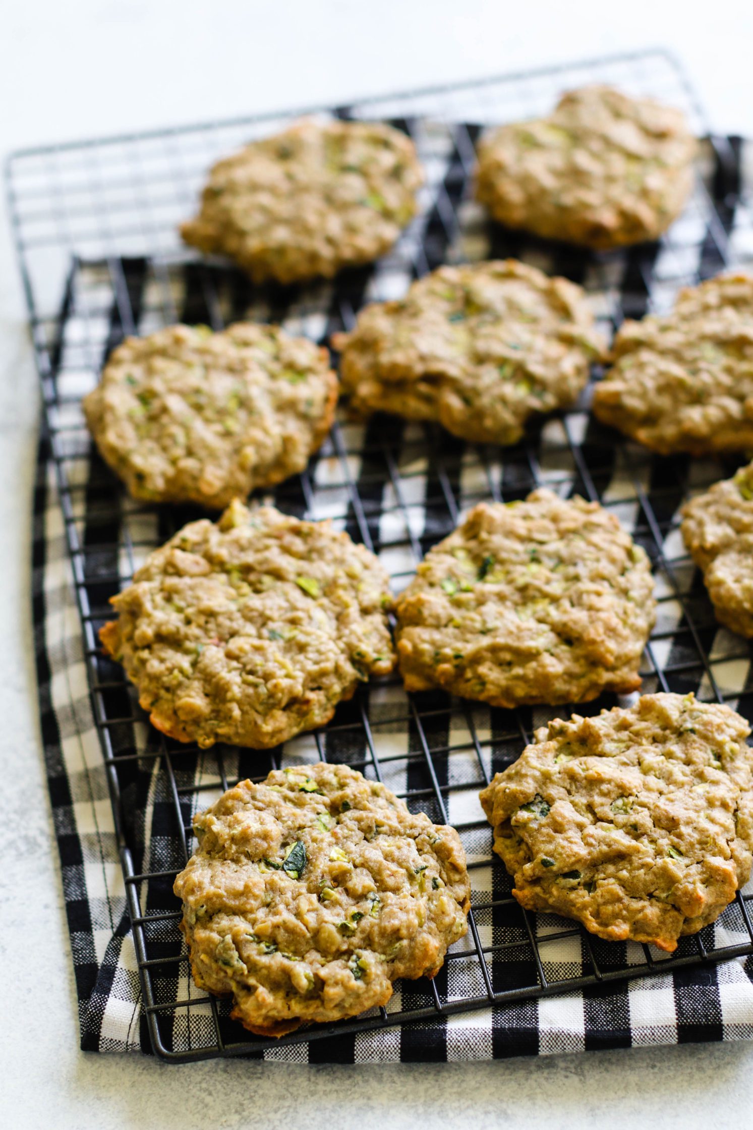 Zucchini Tahini Breakfast Cookies served on cooling rack on top of white and black checkered towel