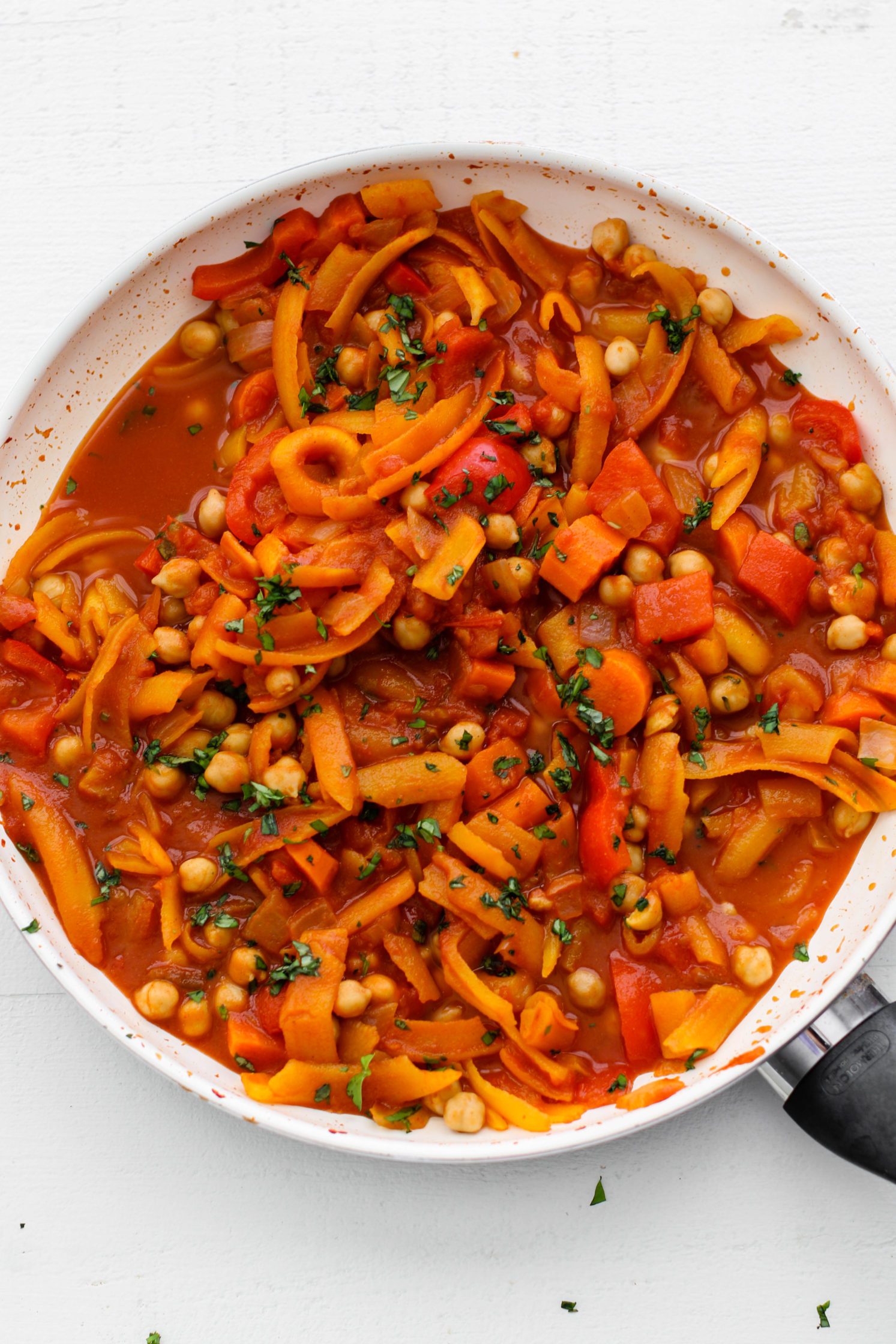 5-Spice Squash & Chickpea Stew in pot topped with herbs 