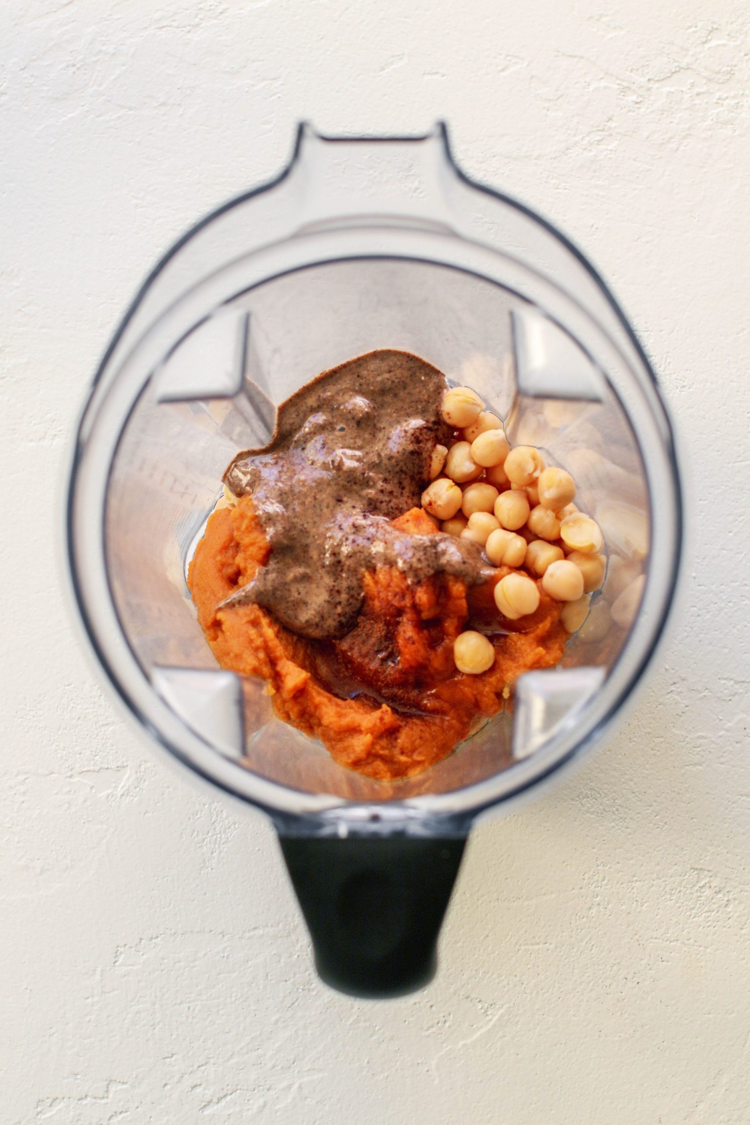 chickpeas, pumpkin, almond butter, maple syrup, and pumpkin pie spice in blender by Flora & Vino