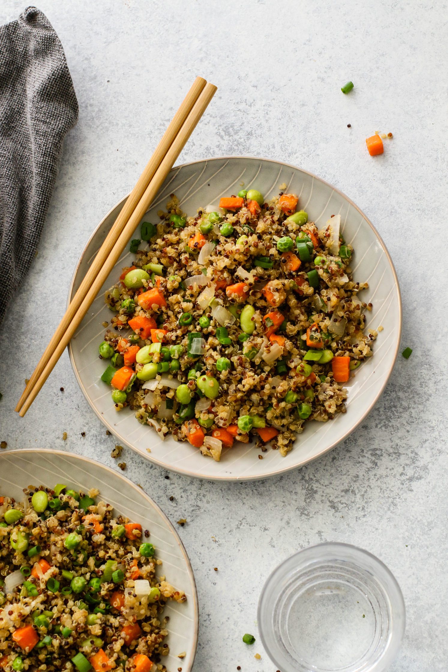 Vegetable Quinoa Fried "Rice" with Edamame by Flora & Vino served on plate with chopsticks