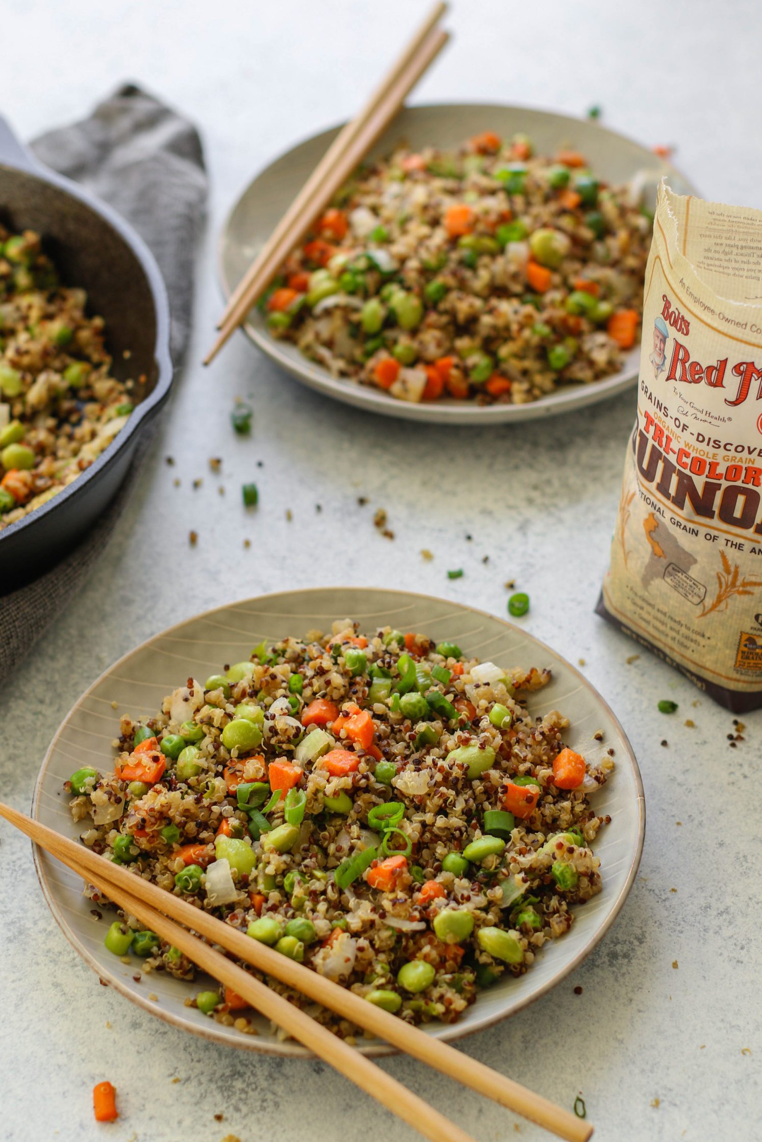 Vegetable Quinoa Fried "Rice" with Edamame by Flora & Vino served on plate with chopsticks