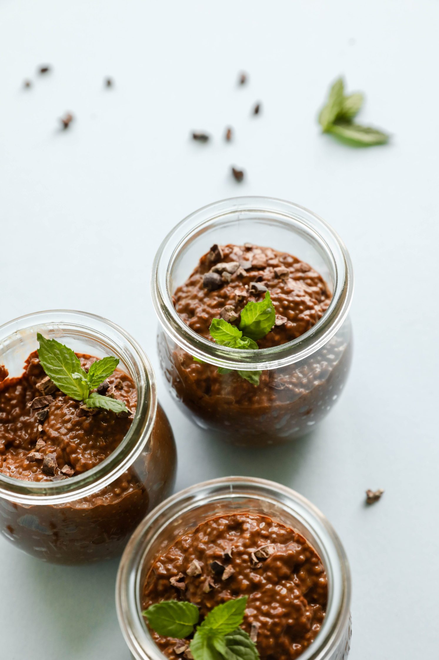 Dark Chocolate Chia Puddings served in Weck jars with fresh mint and cacao nibs on top