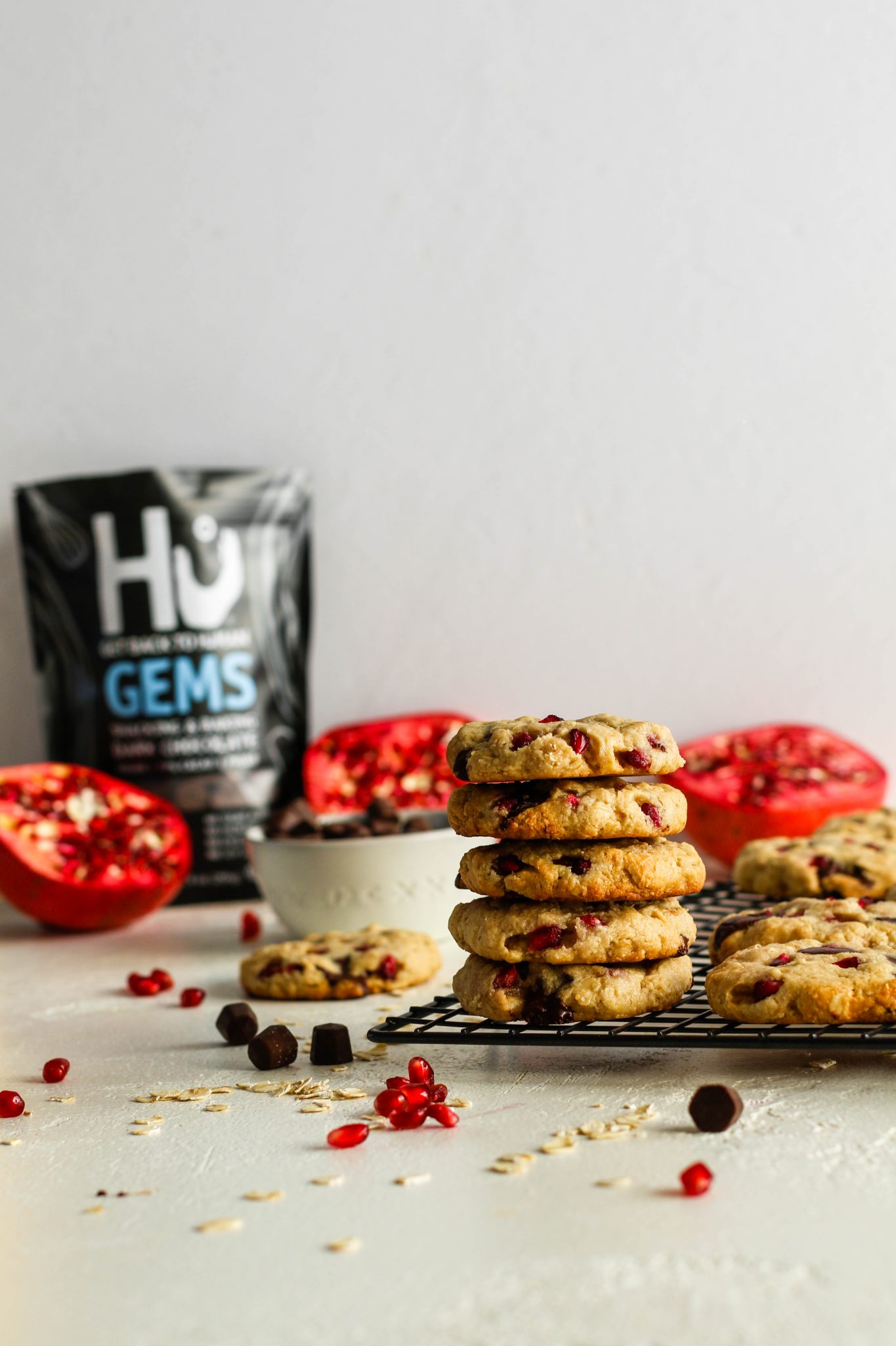 Pomegranate Oatmeal Chocolate Chip Cookies stacked on cooling rack by Flora & Vino 