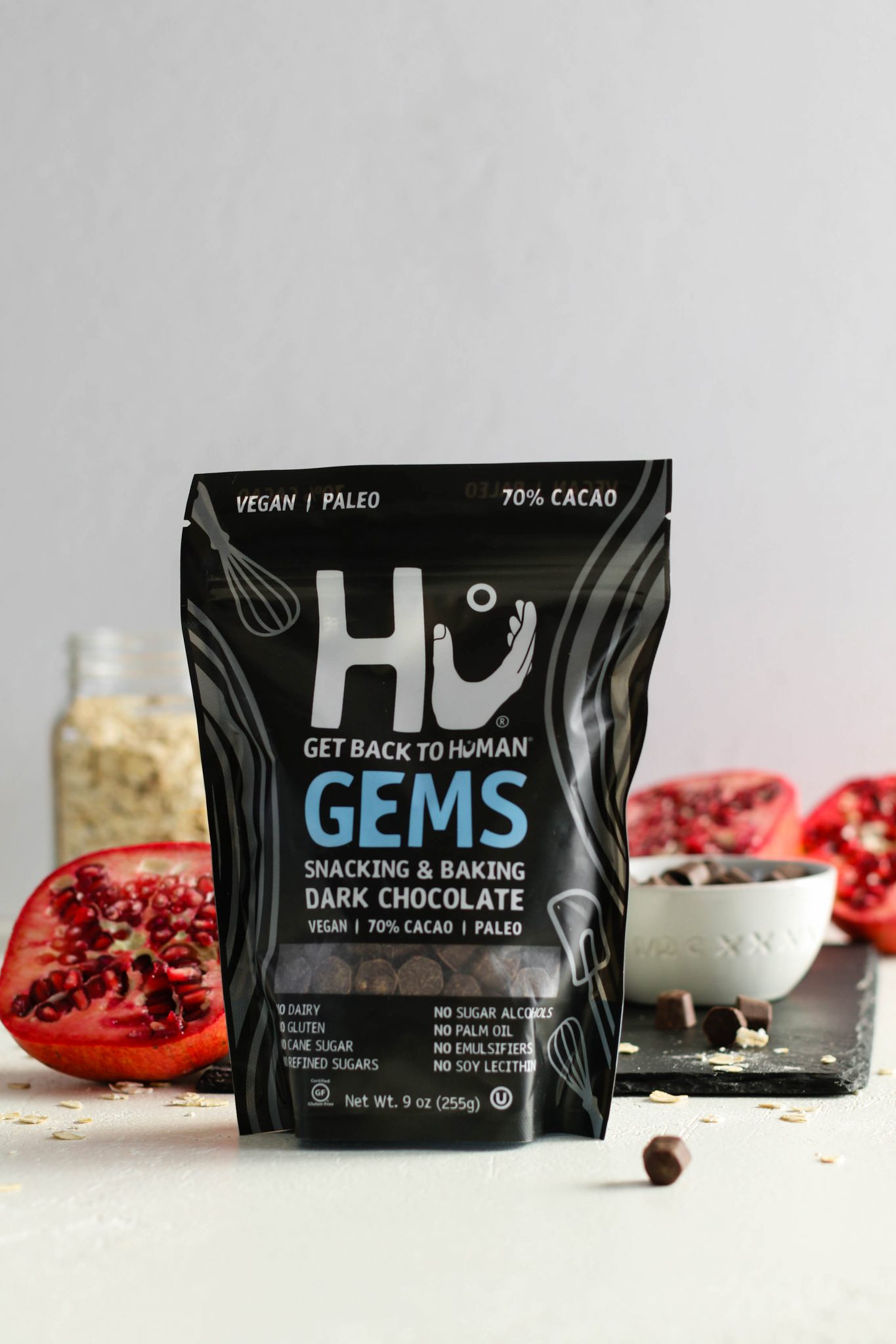 Hu Kitchen Gems with pomegranate behind them by Flora & Vino 