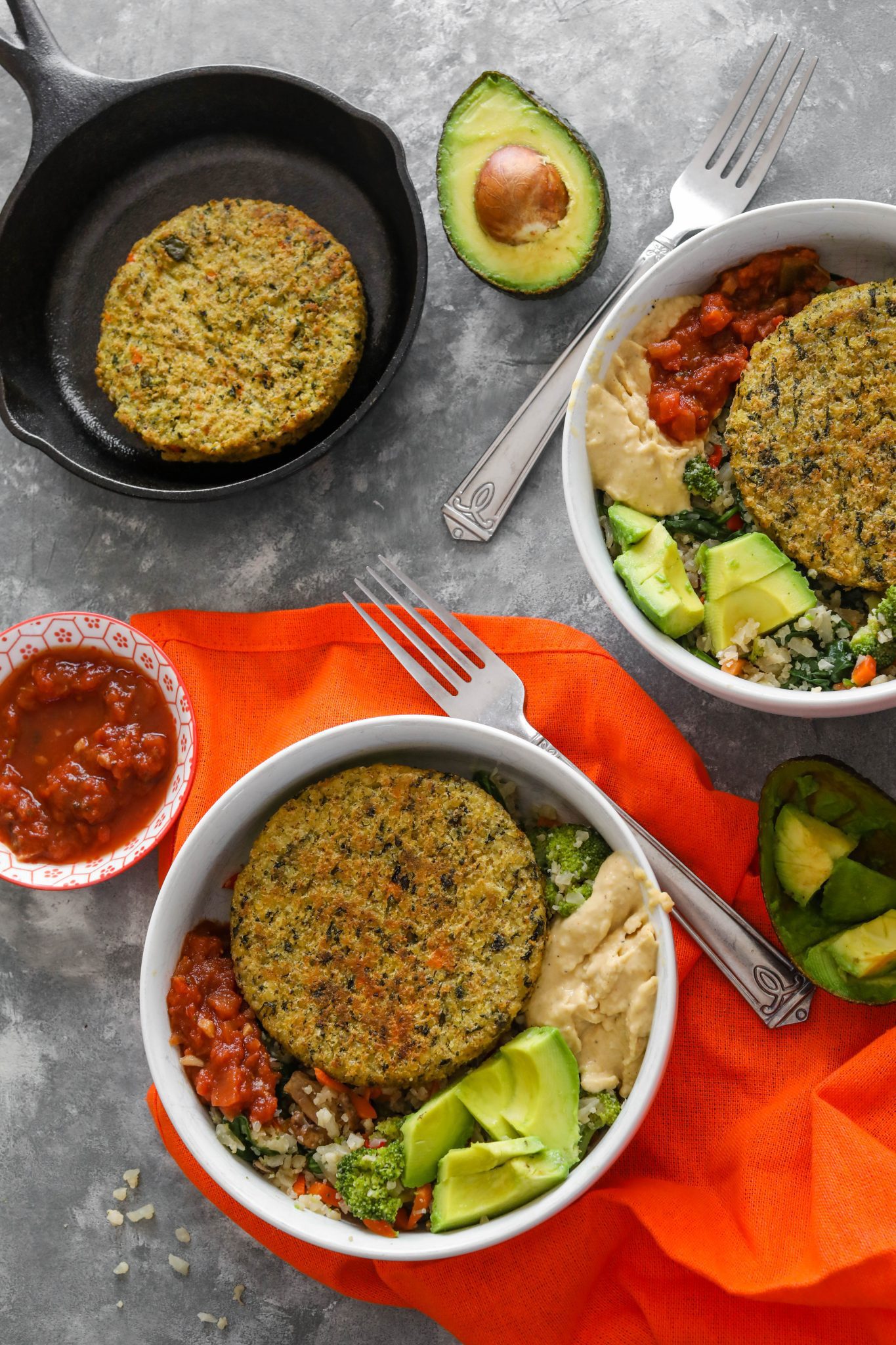 Cauliflower Rice Veggie Burger Bowl served in white bowl with avocado, hummus, and salsa