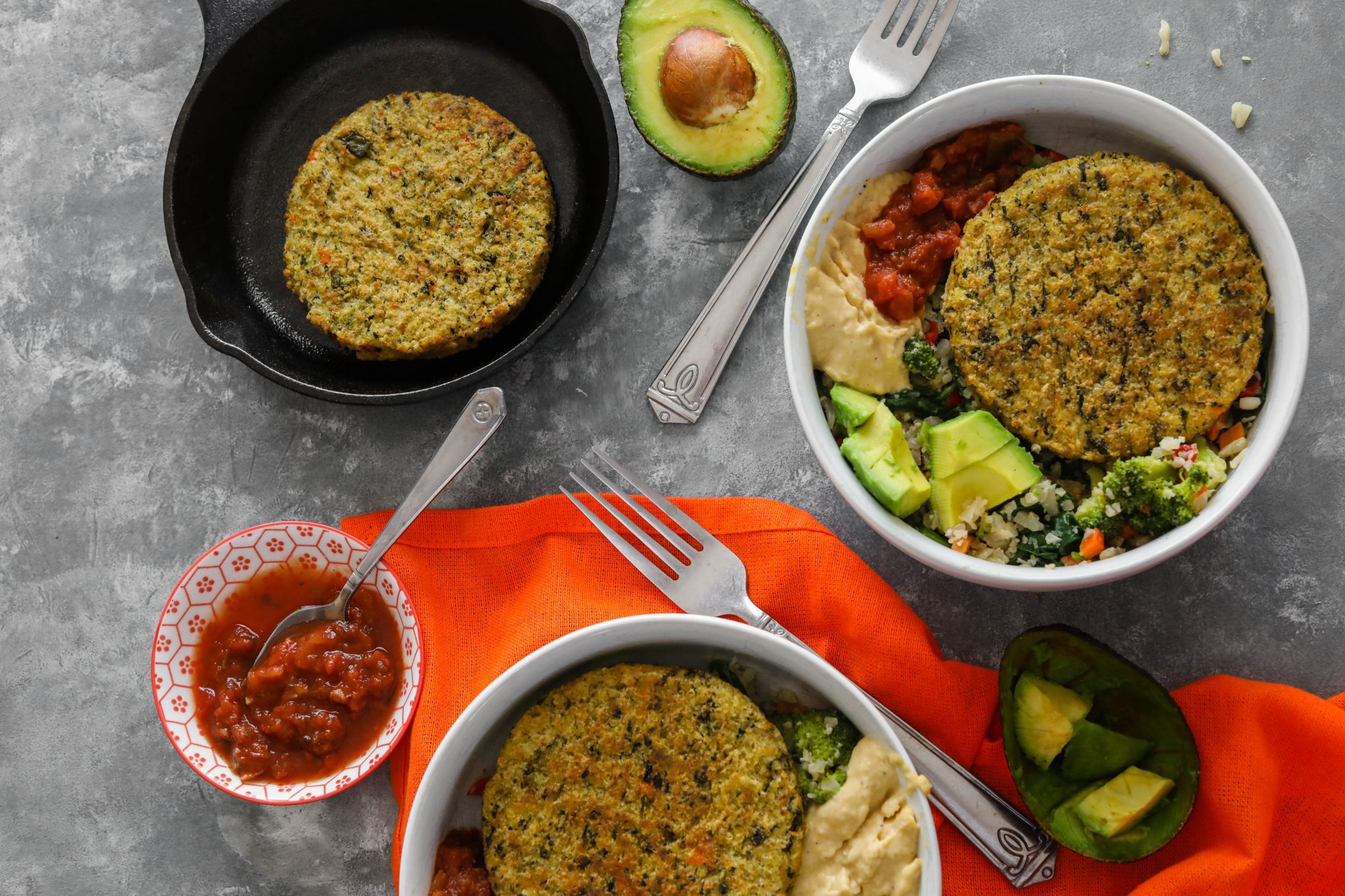 Cauliflower Rice Veggie Burger Bowl served in white bowl with avocado, hummus, and salsa