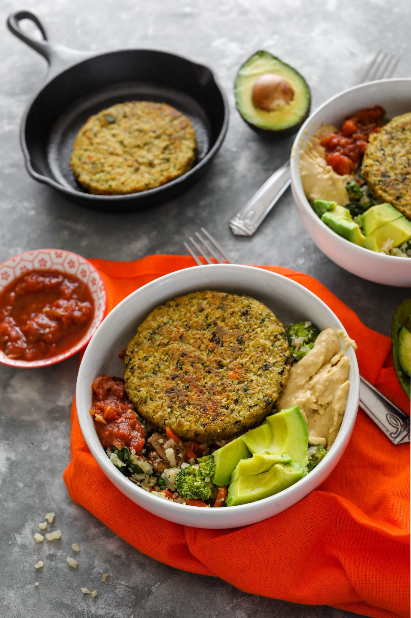 Cauliflower Rice Veggie Burger Bowl served in white bowl with avocado, hummus, and salsa
