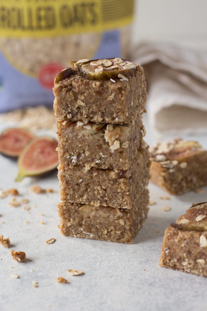 Fig Newton Breakfast Bars stacked with fresh figs scattered by Flora & Vino