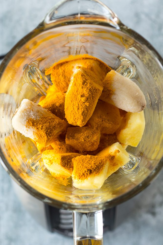Pineapple Turmeric Tahini Shake ingredients in blender by Flora & Vino