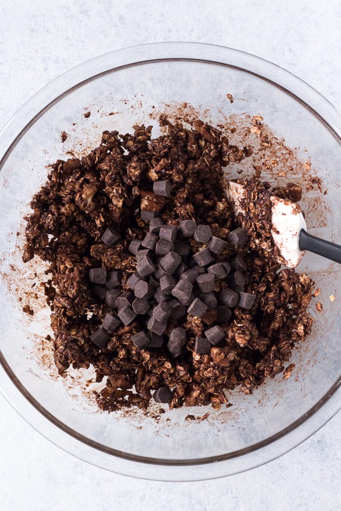 Chocolate Almond Butter Granola mixed in bowl with chocolate chips on top Flora & Vino