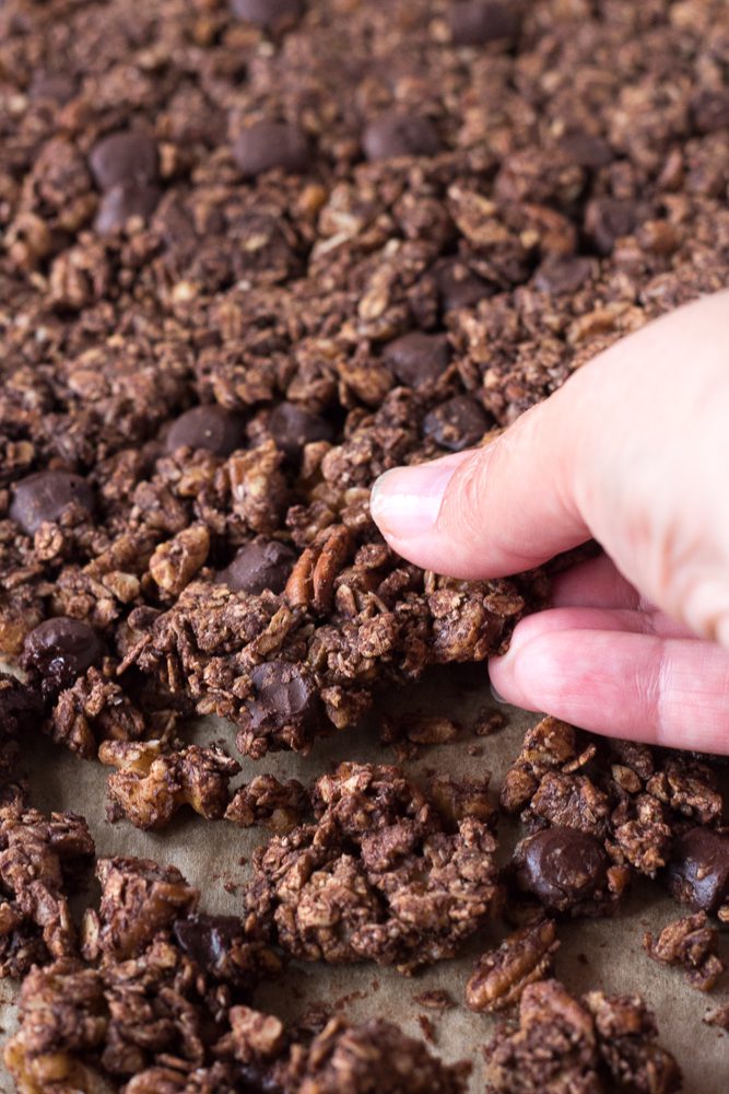 Chocolate Almond Butter Granola broken into chunks with hand by Flora & Vino