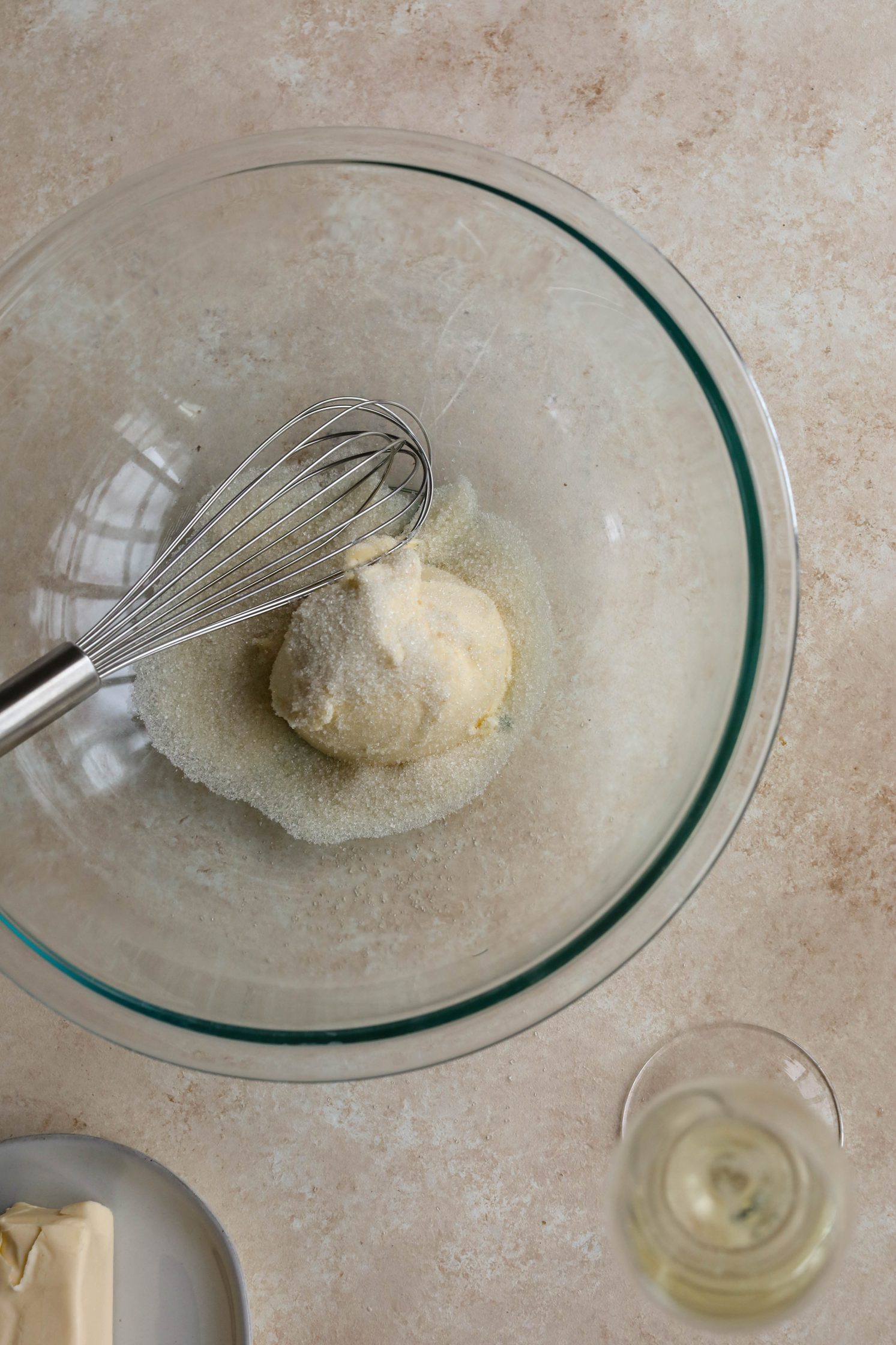 butter and sugar in a bowl with a glass of Prosecco by Flora & Vino