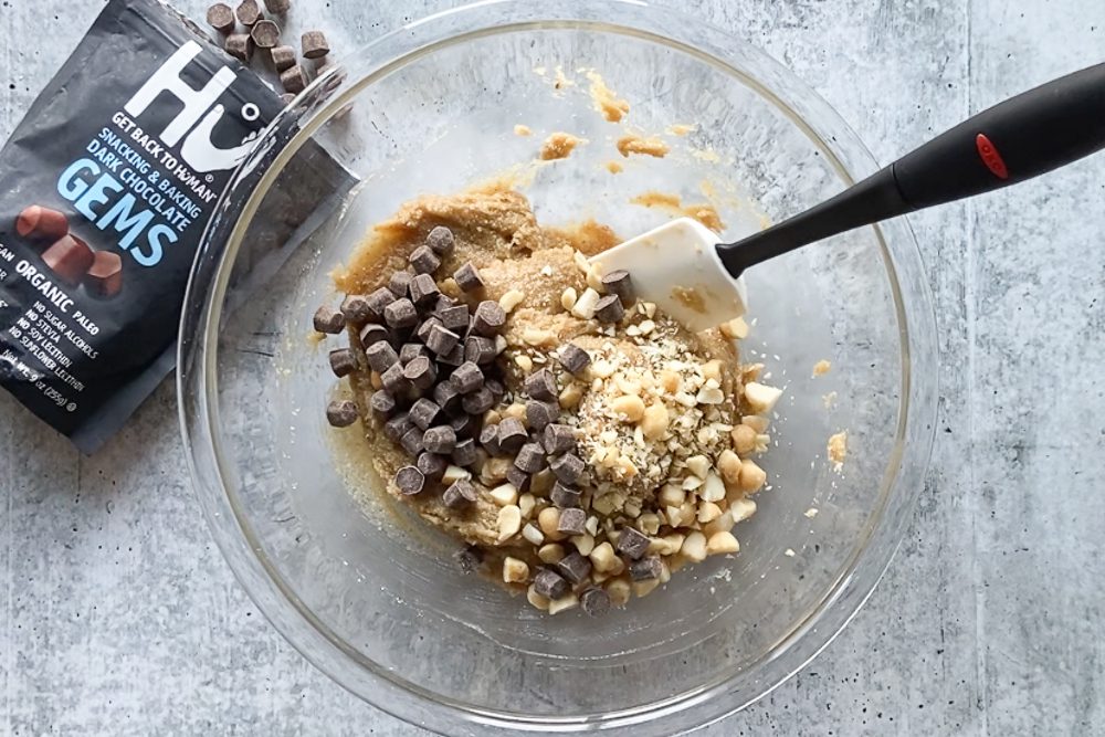 cookie batter with chocolate chunks mixed in with a spatula by Flora & Vino
