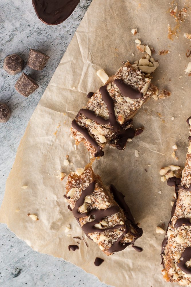 one Date Caramel Nougat Bar broken in half by Flora & Vino