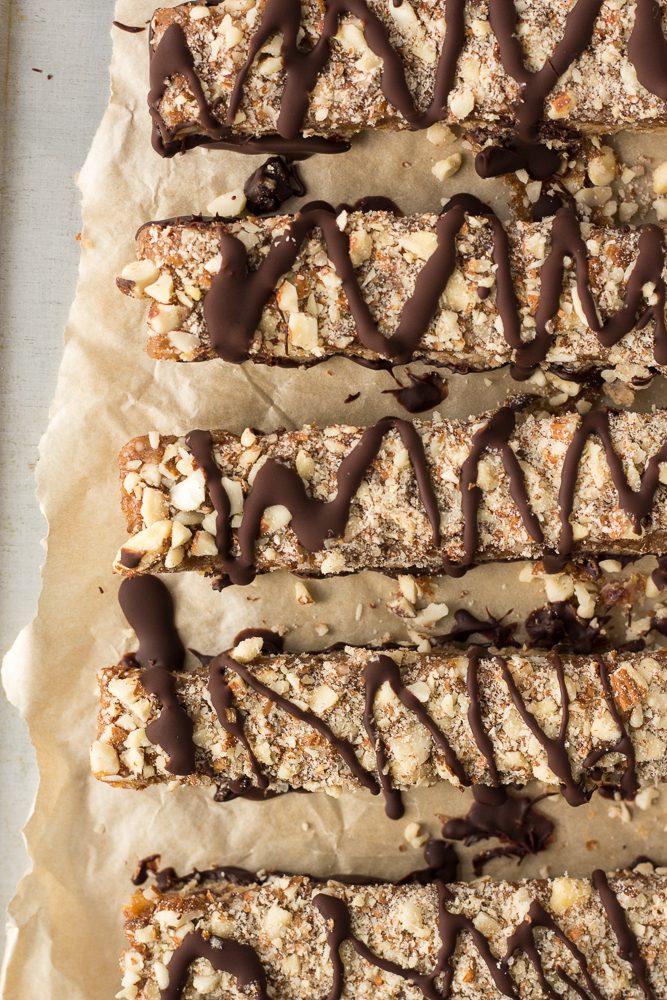 Date Caramel Nougat Bars sliced on parchment paper by Flora & Vino