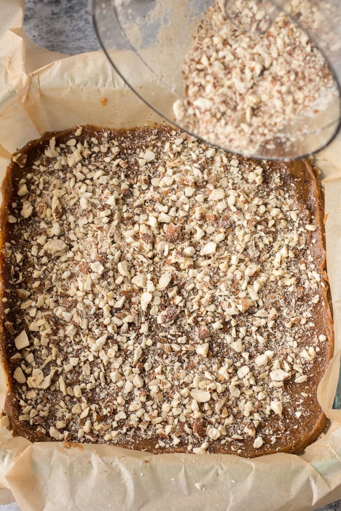crushed almonds sprinkled on top of date caramel and nougat by Flora & Vino
