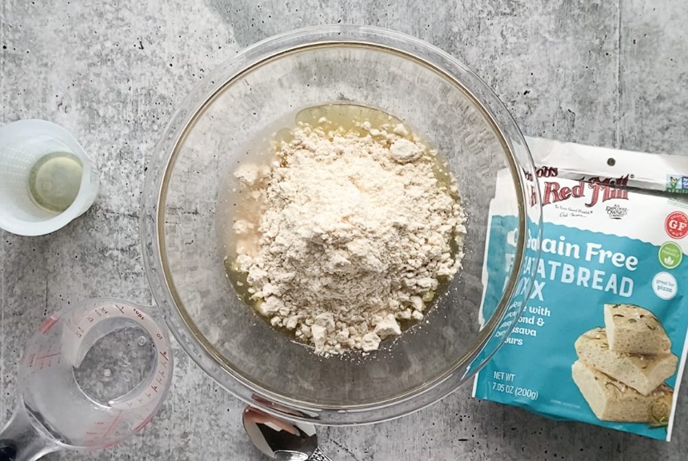 mixing grain-free Flatbread Pizza crust dough in glass bowl 