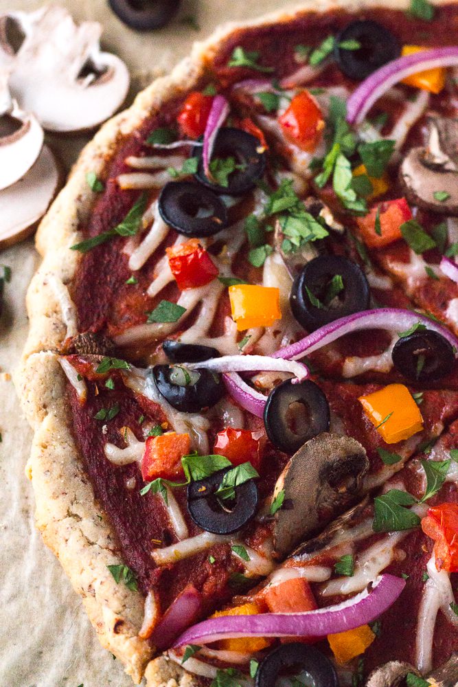 Veggie Lover's Flatbread Pizza cut in slices and served on parchment paper sprinkled with herbs 
