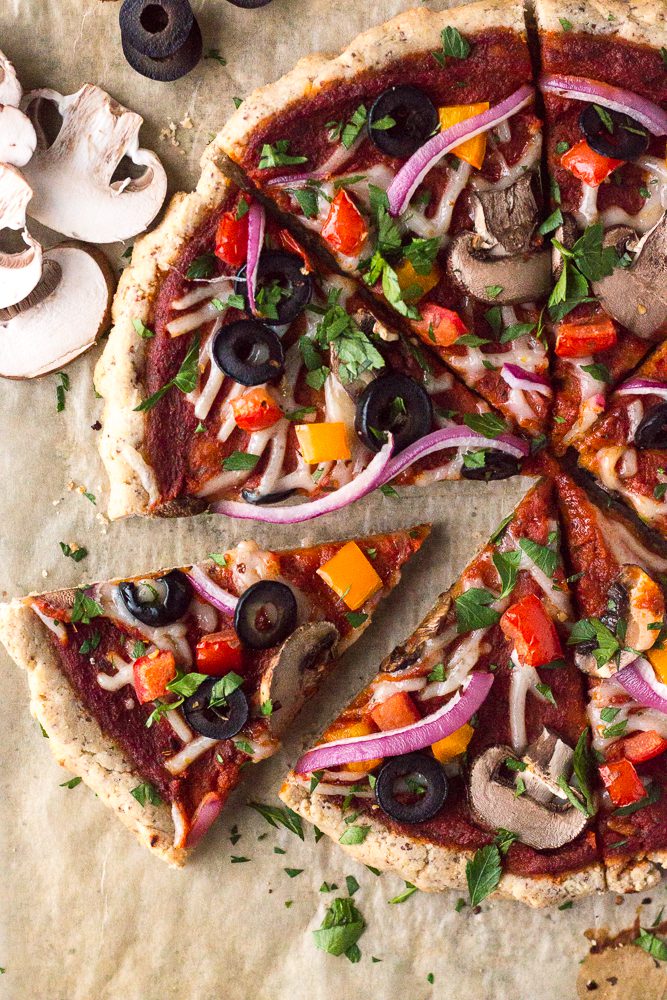 Veggie Lover's Flatbread Pizza cut in slices and served on parchment paper sprinkled with herbs 