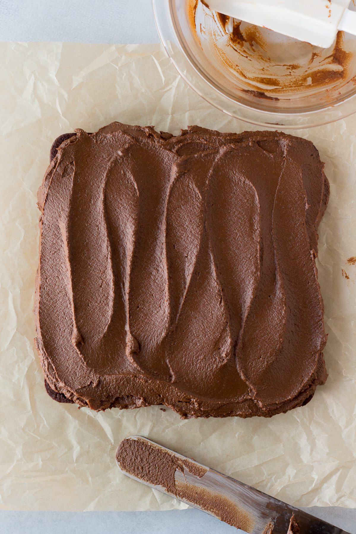 Vegan Chocolate Cake frosted with Sweet Potato Frosting on parchment paper by Flora & Vino 