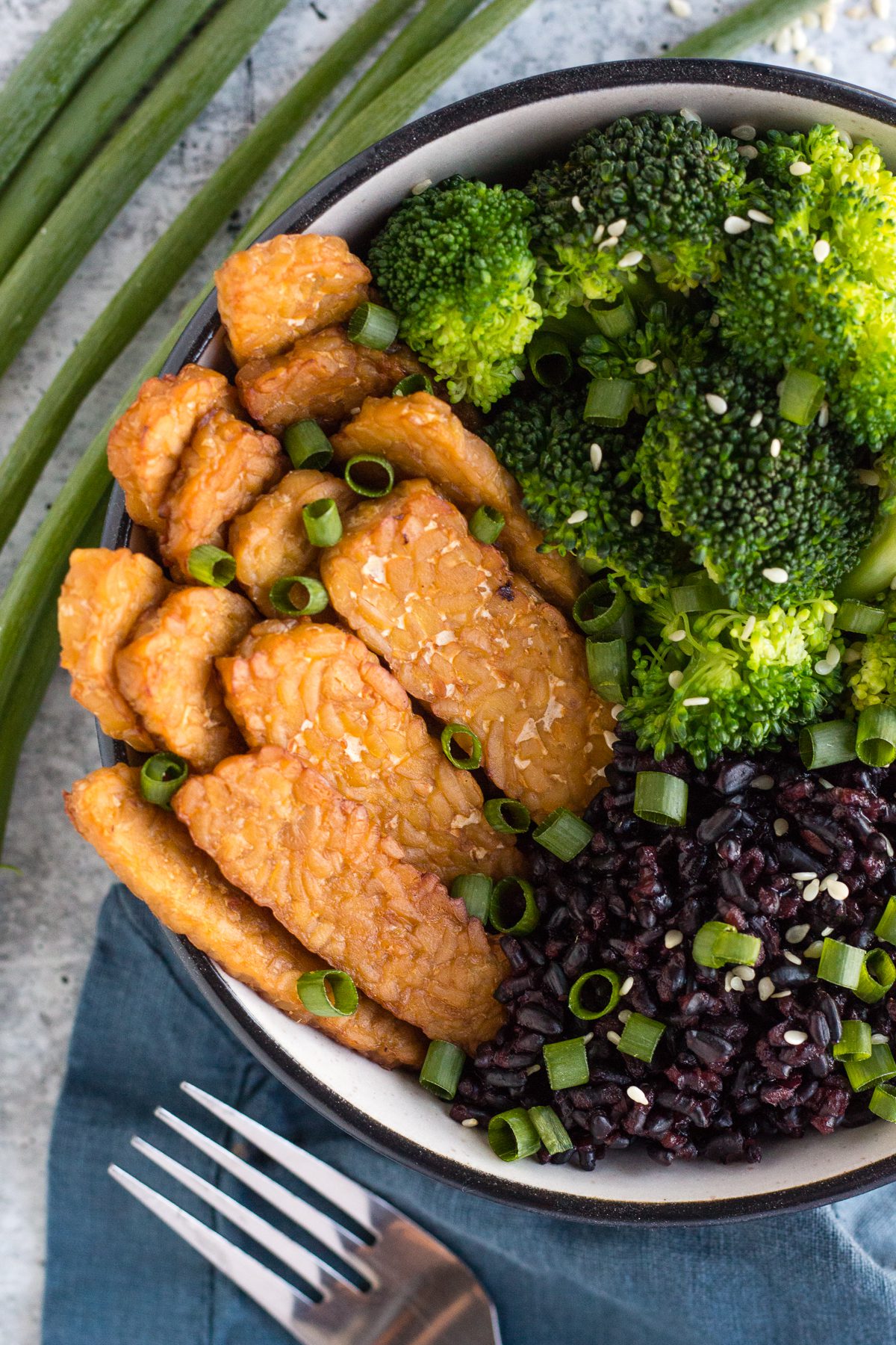 Apple Maple Tempeh Marinade served with black rice and broccoli in a bowl by Flora & Vino