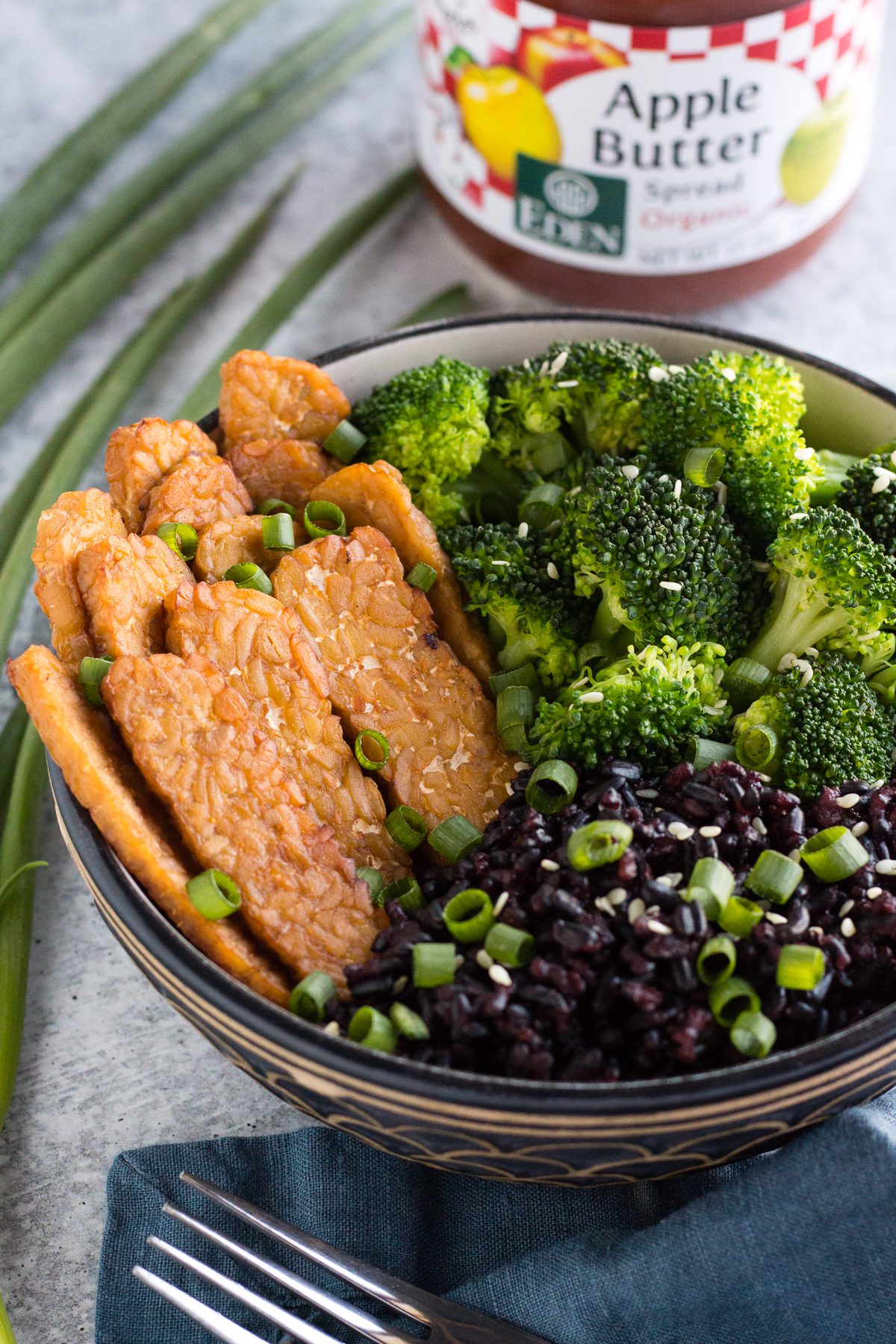 Apple Maple Tempeh Marinade served in a bowl with black rice and broccoli by Flora & Vino
