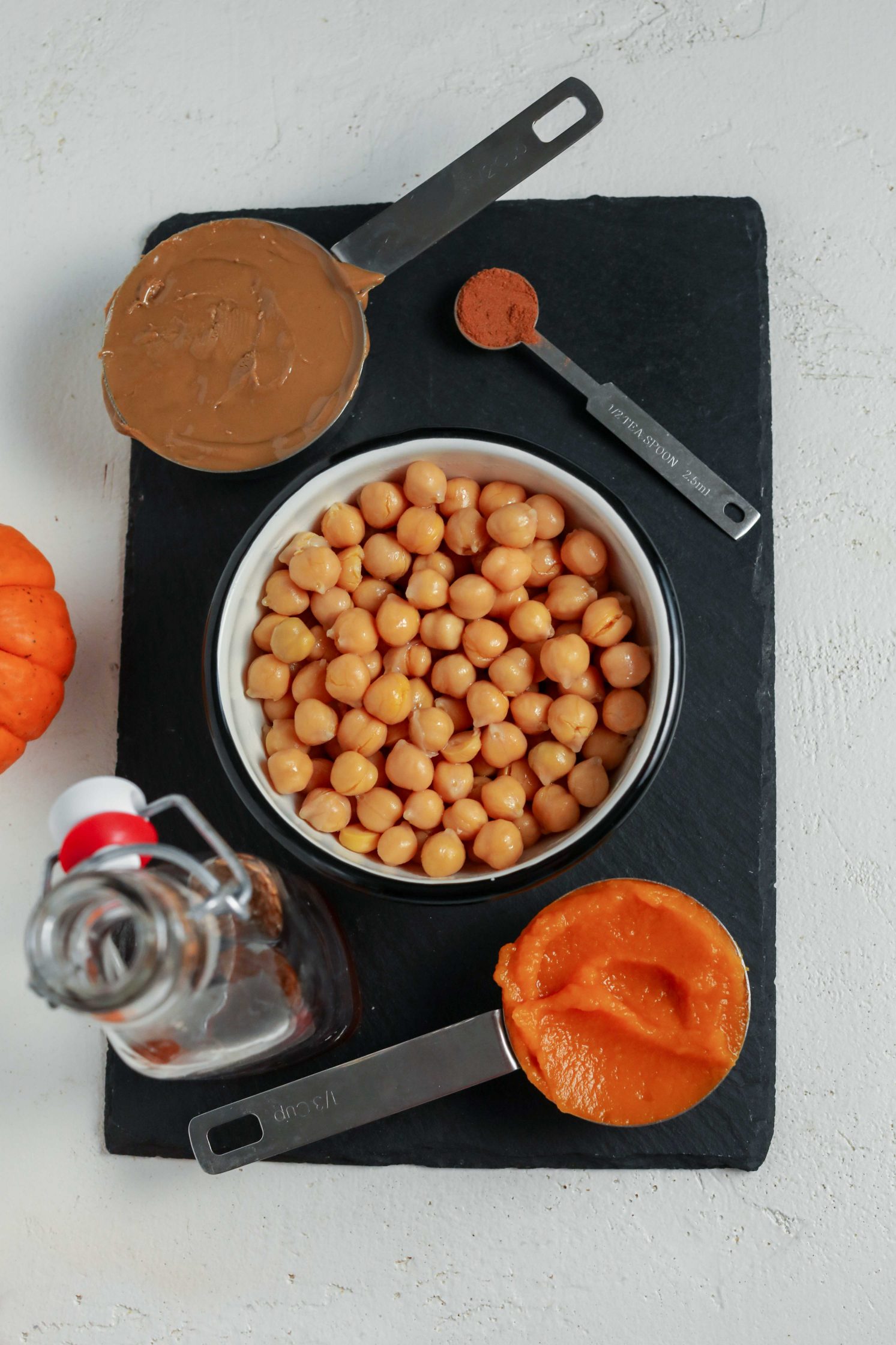 chickpeas, almond butter, pumpkin, cinnamon, and maple syrup on serving board by Flora & Vino