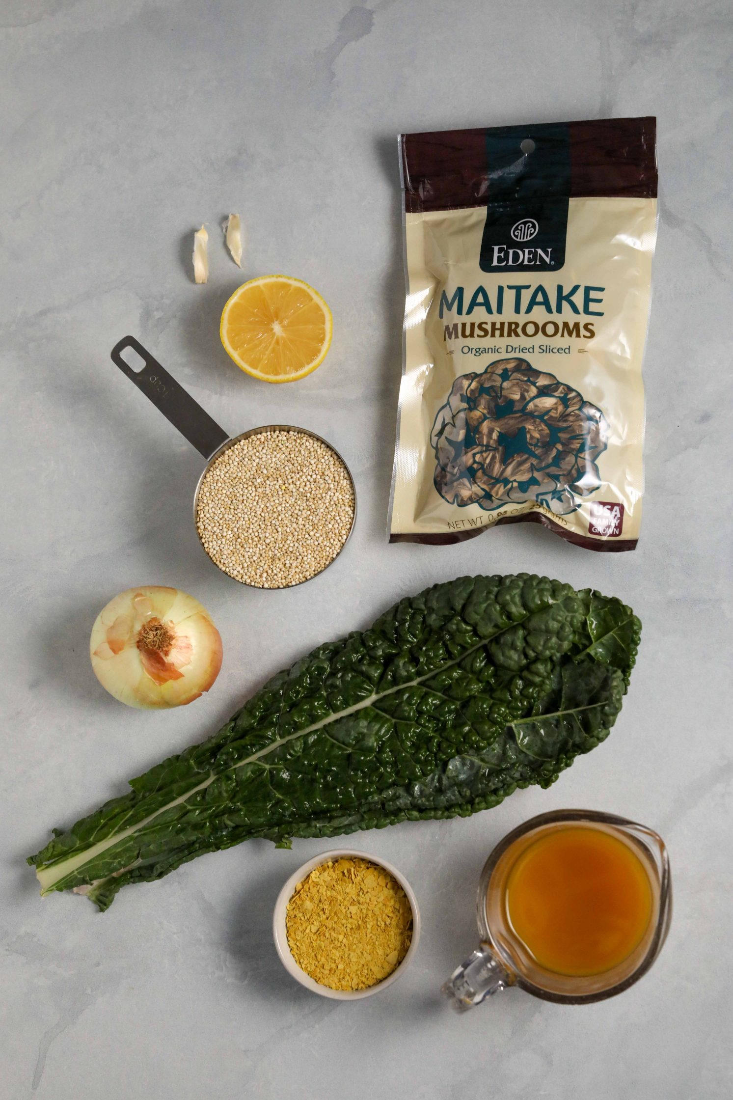 quinoa, lemon, nutritional yeast, onion, vegetable broth, Eden Foods dried mushrooms, kale, and garlic on marble board