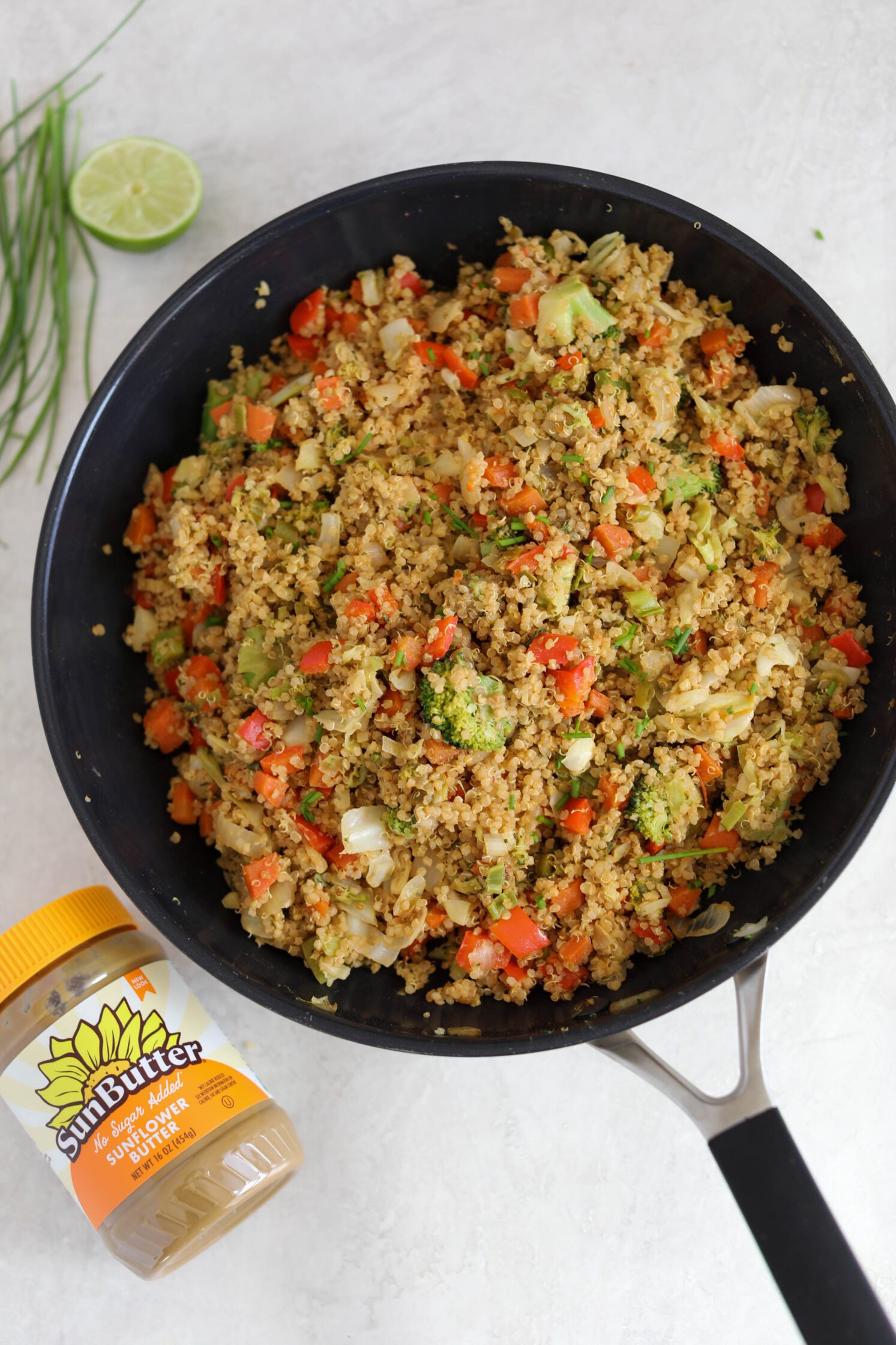 SunButter Quinoa Fried Rice in a cast iron skillet with jar of SunButter on side by Flora & Vino 