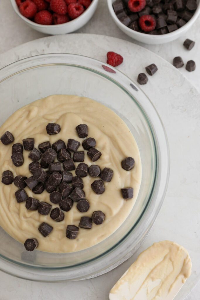white bean blondie batter in bowl with chocolate chips on top by Flora & Vino