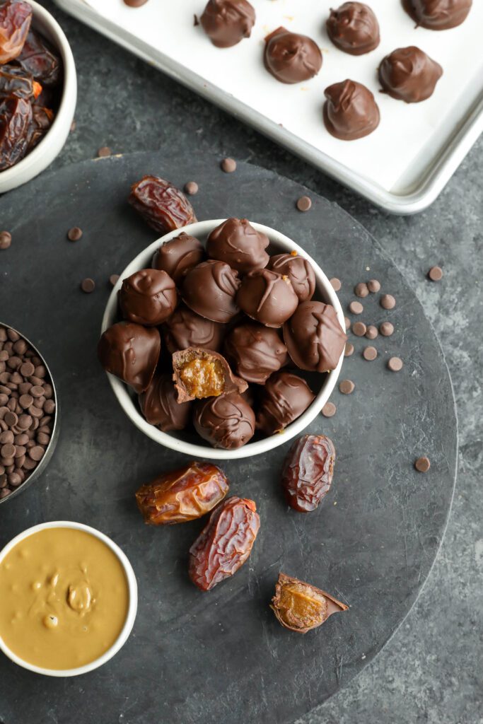 Vegan SunButter Date Caramels served in bowl with SunButter, dates, and chocolate chips by Flora & Vino