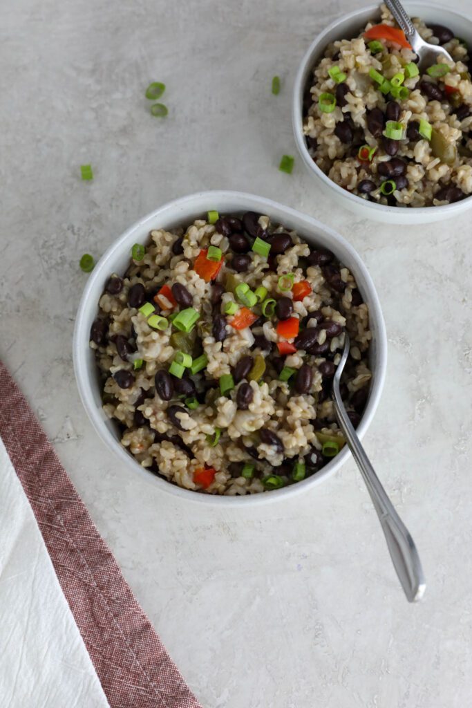 Caribbean Rice & Beans served in bowls with fork and green onions on top