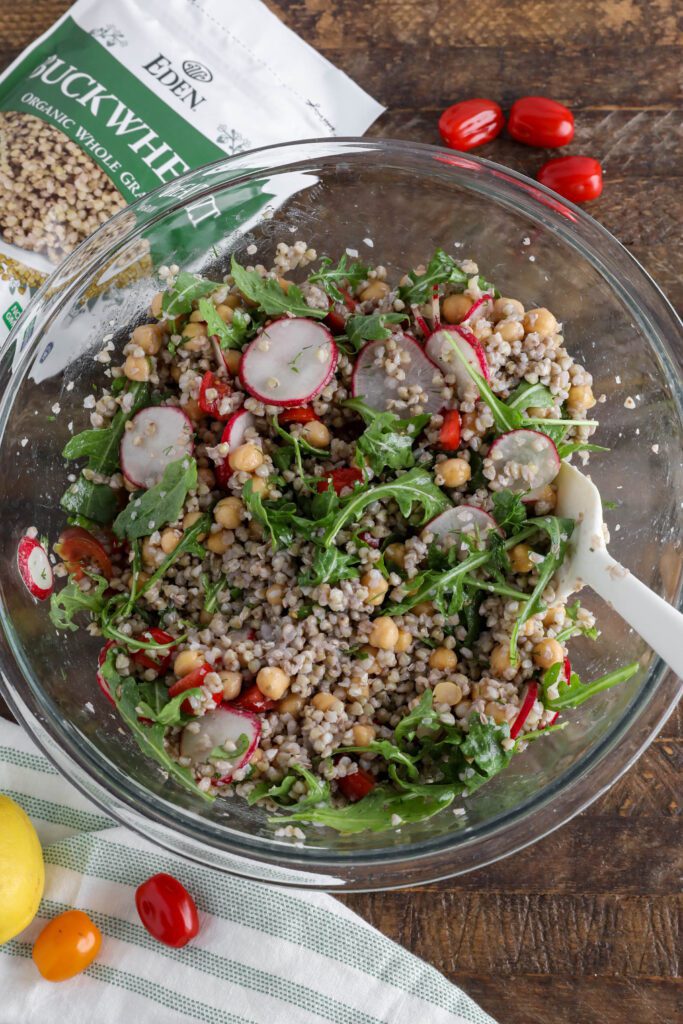 Spring Buckwheat Tabbouleh in bowl with arugula and cherry tomatoes on the side